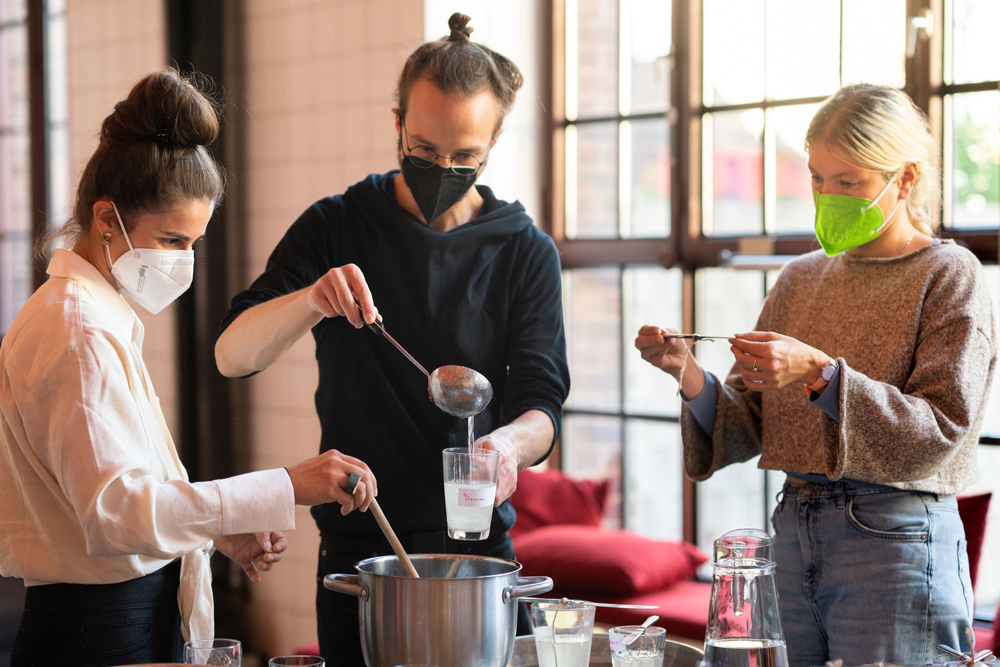 Three participants preparing the solution